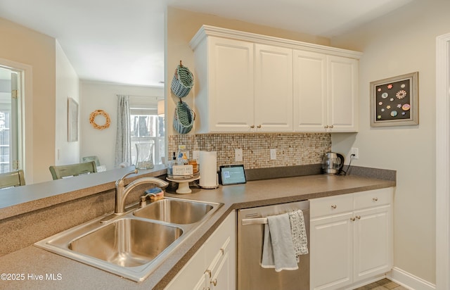 kitchen with a sink, white cabinetry, decorative backsplash, and dishwasher