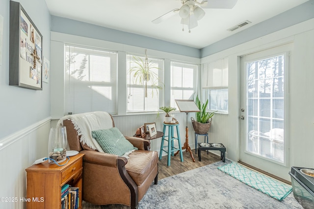 sunroom / solarium featuring visible vents, plenty of natural light, and ceiling fan