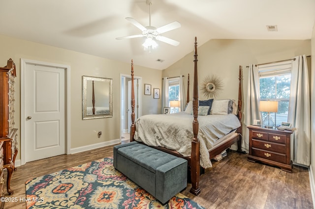 bedroom with lofted ceiling, dark wood-style flooring, multiple windows, and baseboards