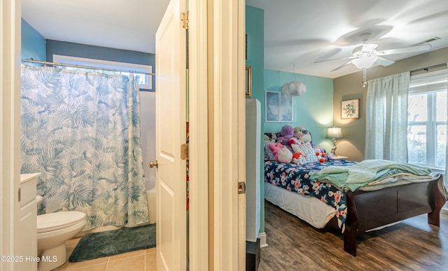 tiled bedroom with ceiling fan