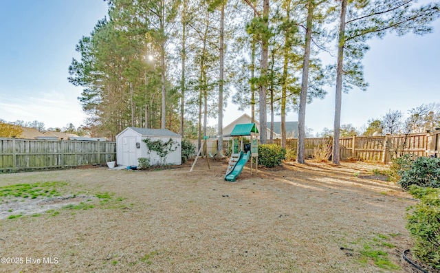 view of play area featuring a storage shed, an outbuilding, and a fenced backyard