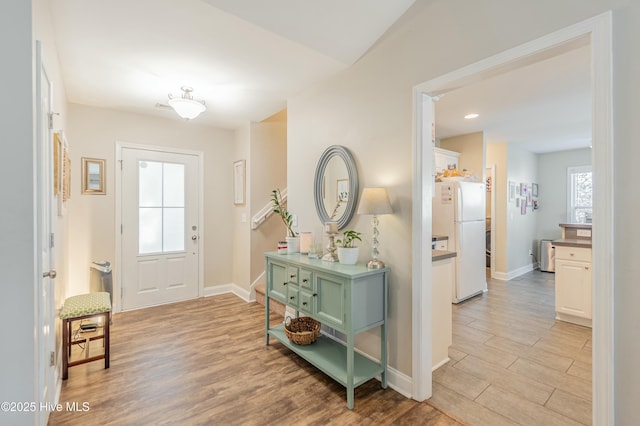 entrance foyer with light wood-type flooring, baseboards, and recessed lighting