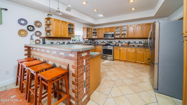 kitchen featuring dark countertops, appliances with stainless steel finishes, brown cabinets, glass insert cabinets, and open shelves