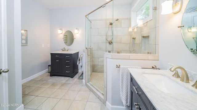 bathroom featuring two vanities, a stall shower, tile patterned flooring, and a sink