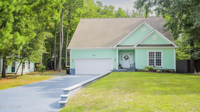 view of front of home featuring an attached garage, fence, driveway, roof with shingles, and a front lawn