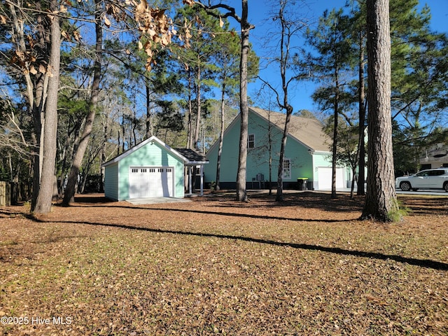 exterior space featuring driveway and an outbuilding