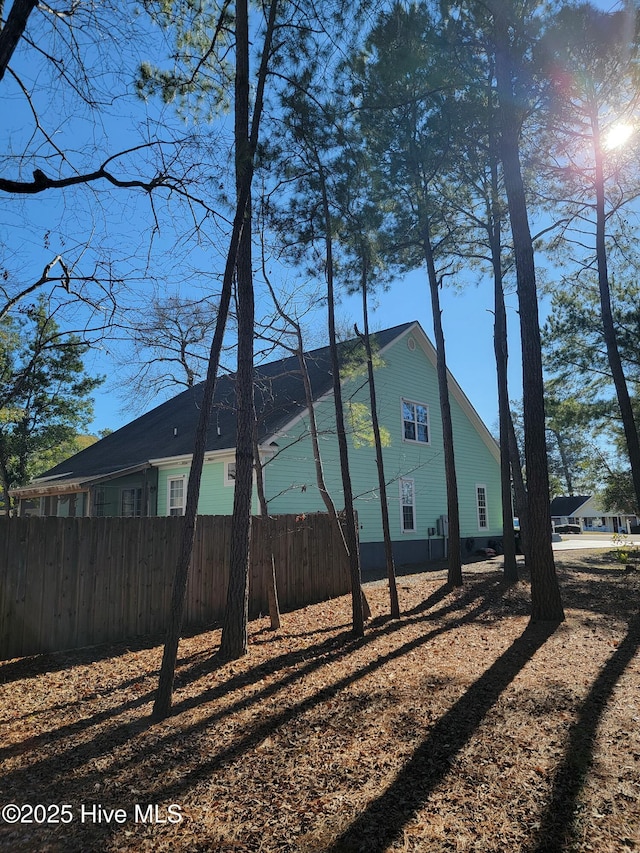 view of side of property featuring fence