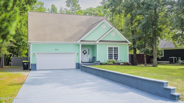 view of front of house featuring a garage, a front yard, concrete driveway, and fence