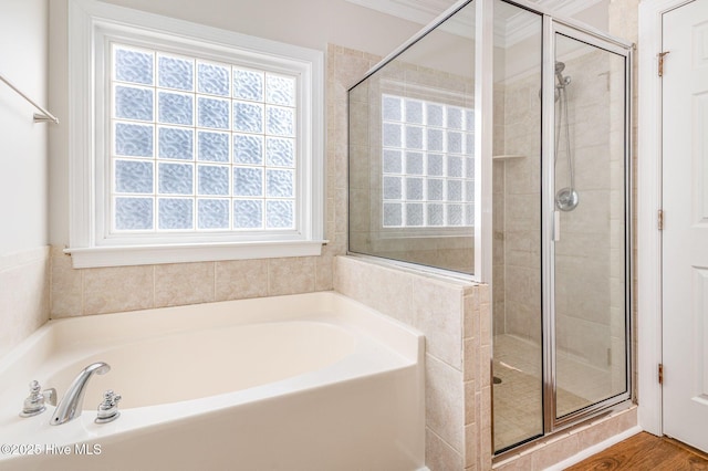 bathroom with a shower stall and a bath