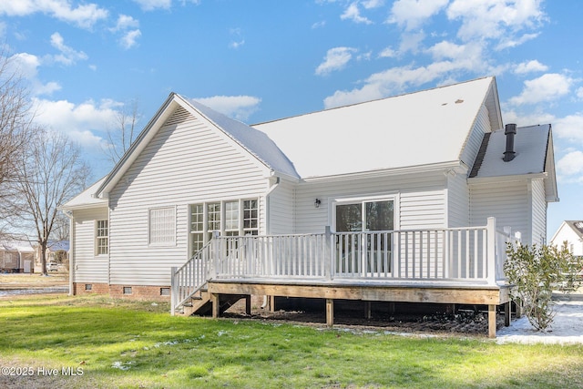 rear view of house with a yard and a wooden deck