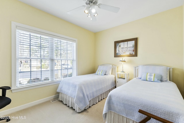 bedroom with baseboards, a ceiling fan, and light colored carpet