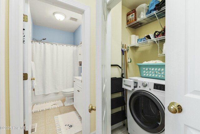 washroom featuring visible vents, laundry area, tile patterned flooring, and washer / dryer