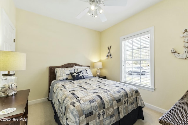 carpeted bedroom featuring a ceiling fan and baseboards