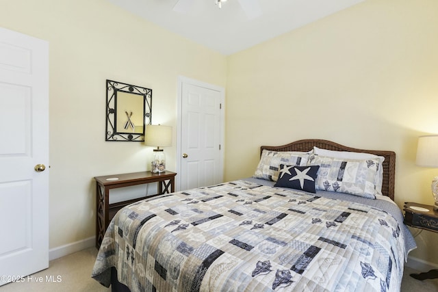 carpeted bedroom featuring baseboards and a ceiling fan