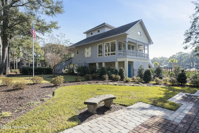 view of front of property with a front yard, fence, and stairs