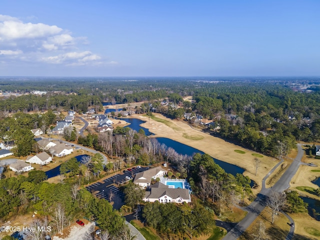 drone / aerial view featuring a water view and a view of trees