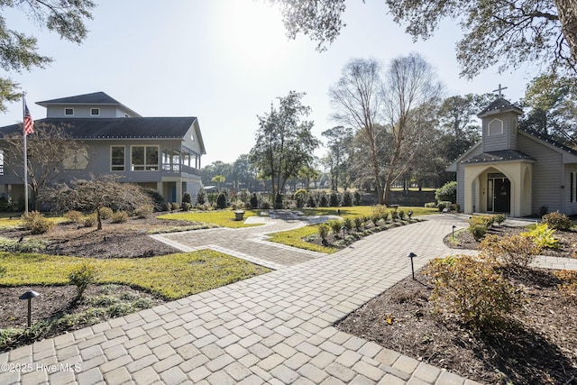 view of home's community with decorative driveway