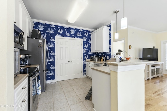 kitchen with wallpapered walls, appliances with stainless steel finishes, ornamental molding, white cabinetry, and a sink