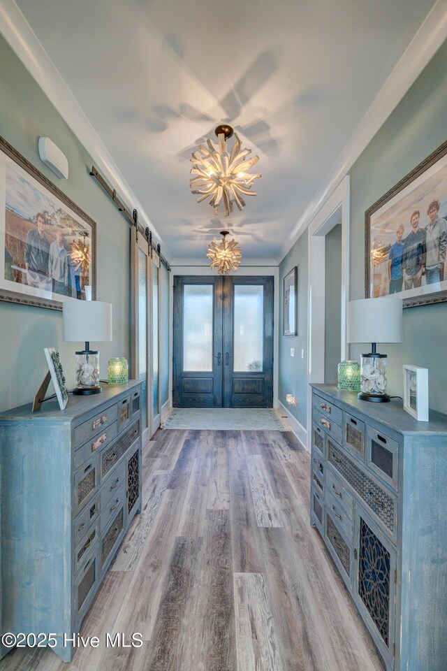 laundry room featuring cabinet space, light wood-style flooring, baseboards, and washer and dryer