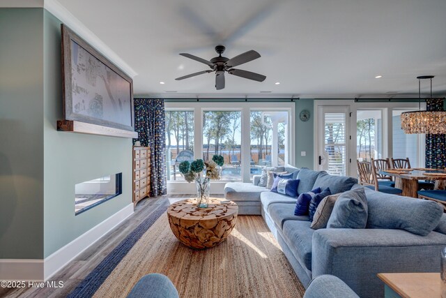 bedroom with ornamental molding, wood finished floors, visible vents, and baseboards