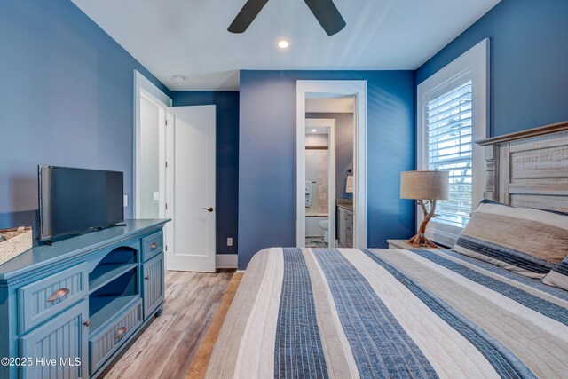 bedroom with a ceiling fan, baseboards, visible vents, light wood-style floors, and ensuite bath