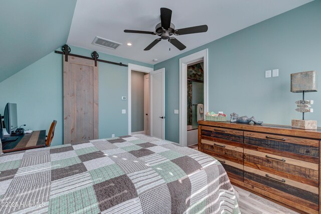 bedroom with lofted ceiling, ceiling fan, wood finished floors, visible vents, and baseboards