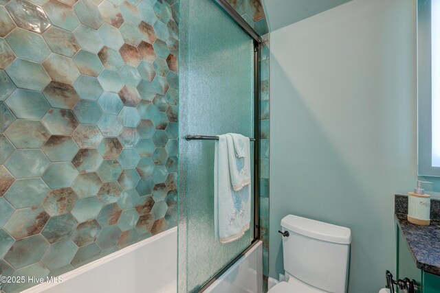 bathroom featuring toilet, shower / bathtub combination, and vanity