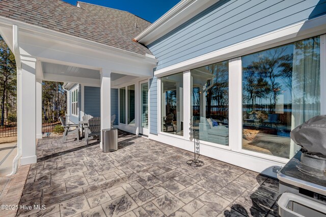 view of patio / terrace featuring a fenced in pool, a fenced backyard, grilling area, an in ground hot tub, and outdoor dining space