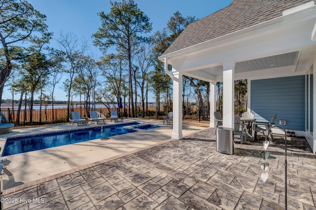 view of pool with a fenced in pool, a patio, and fence