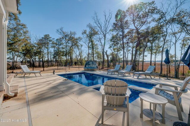 view of swimming pool with a fenced in pool, a patio area, fence, and a jacuzzi