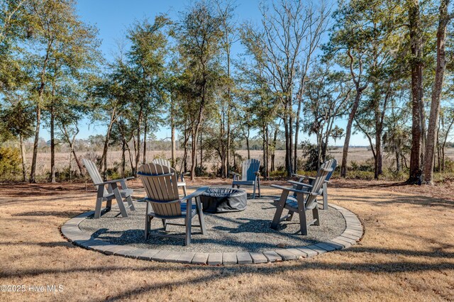 rear view of house with a patio area and a fire pit