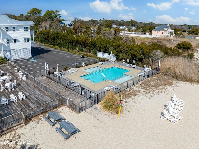 pool with a patio and fence