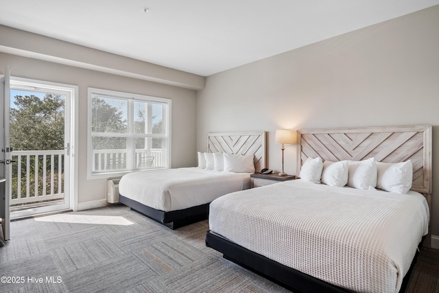 bedroom featuring access to outside, light colored carpet, and baseboards