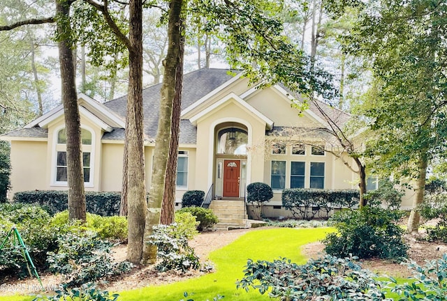 view of front of home with a shingled roof, crawl space, and stucco siding