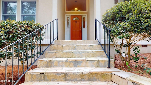 doorway to property with stucco siding