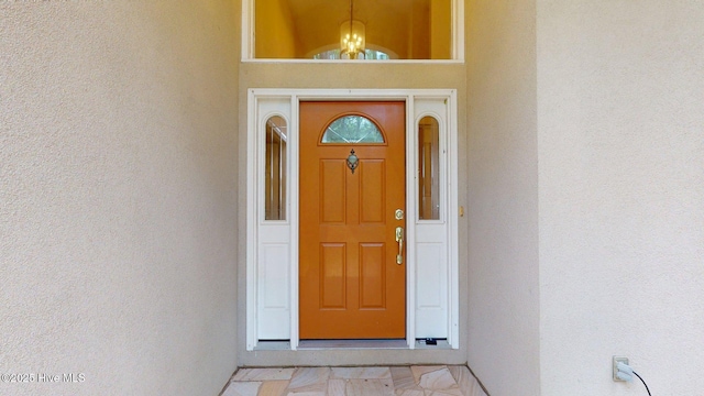view of exterior entry featuring stucco siding