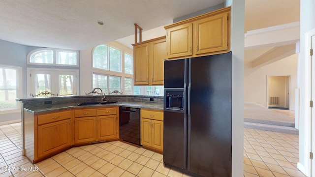 kitchen featuring a sink, light tile patterned floors, black appliances, visible vents, and dark countertops
