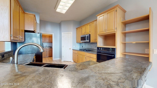 kitchen with a sink, decorative backsplash, light tile patterned flooring, open shelves, and black appliances