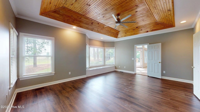 empty room featuring wooden ceiling, ceiling fan, a raised ceiling, crown molding, and wood finished floors