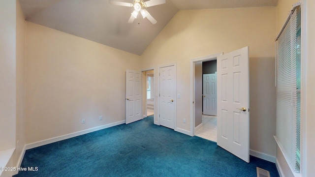 unfurnished bedroom with carpet floors, ceiling fan, baseboards, visible vents, and high vaulted ceiling