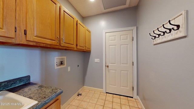 clothes washing area with cabinet space, light tile patterned floors, electric dryer hookup, hookup for a washing machine, and baseboards