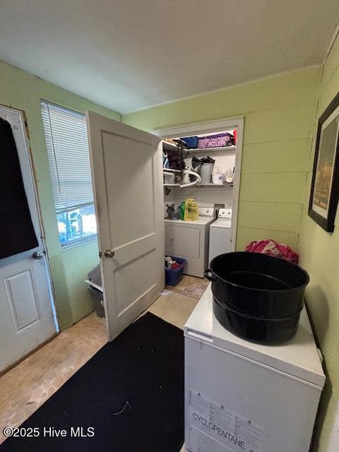 laundry area with laundry area and washer and clothes dryer