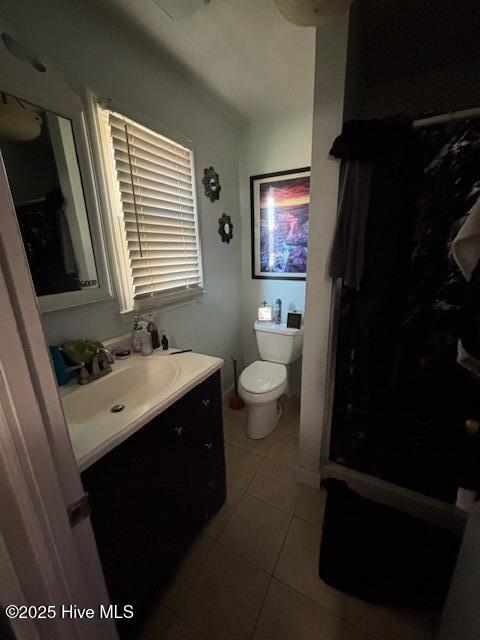 bathroom with vanity, tile patterned flooring, and toilet