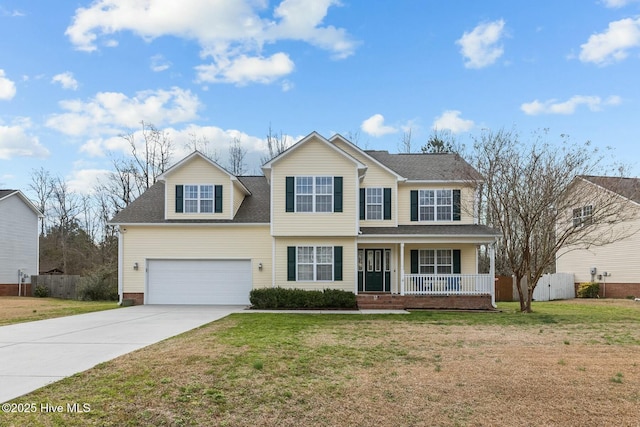 view of front facade with driveway, fence, a porch, and a front yard