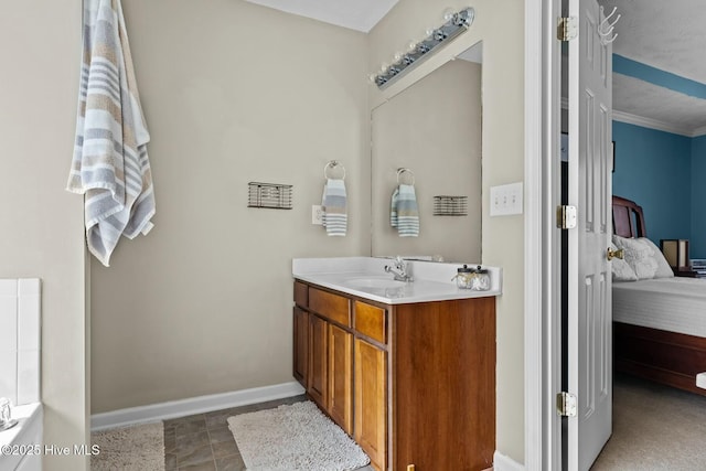 full bathroom with baseboards, connected bathroom, and vanity