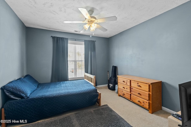 bedroom with baseboards, visible vents, and light colored carpet