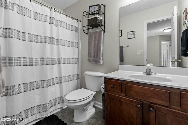 full bathroom with curtained shower, vanity, toilet, and tile patterned floors