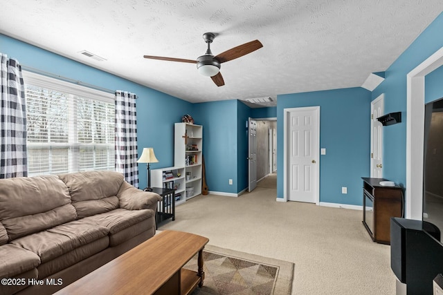 living area with light colored carpet, visible vents, and baseboards