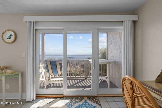 doorway featuring light tile patterned flooring and plenty of natural light