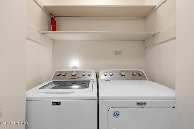 clothes washing area with laundry area and washing machine and clothes dryer